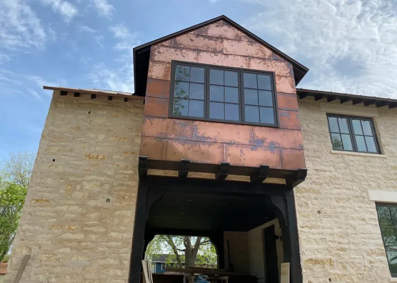 Copper metal panel facade on a stone building for Skylight Installation in Olivehurst