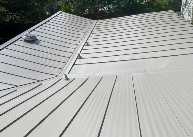 Solar attic fan installed on a metal roof for Roof Ventilation in Olivehurst