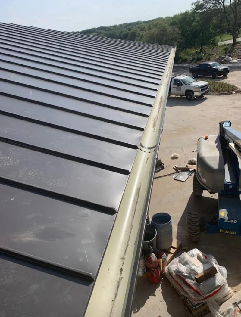 Standing seam panel and gutter detail on a metal roofing jobsite in Olivehurst